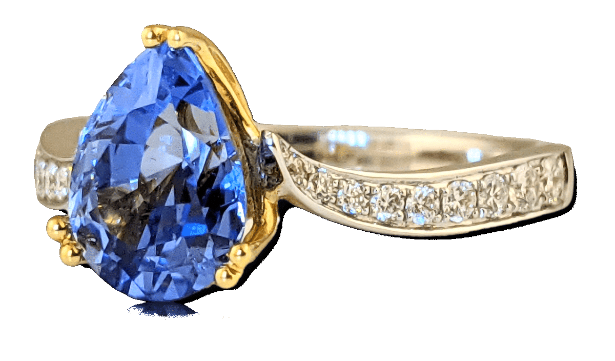 blue pear sapphire engagement ring with diamonds around the band