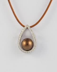 chocolate pearl diamond pendant with a leather cord.