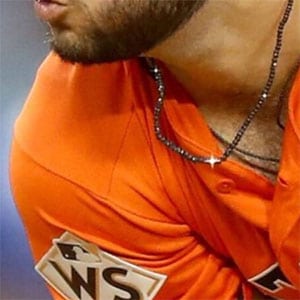 Baseball player wearing black diamond necklace jewelry.